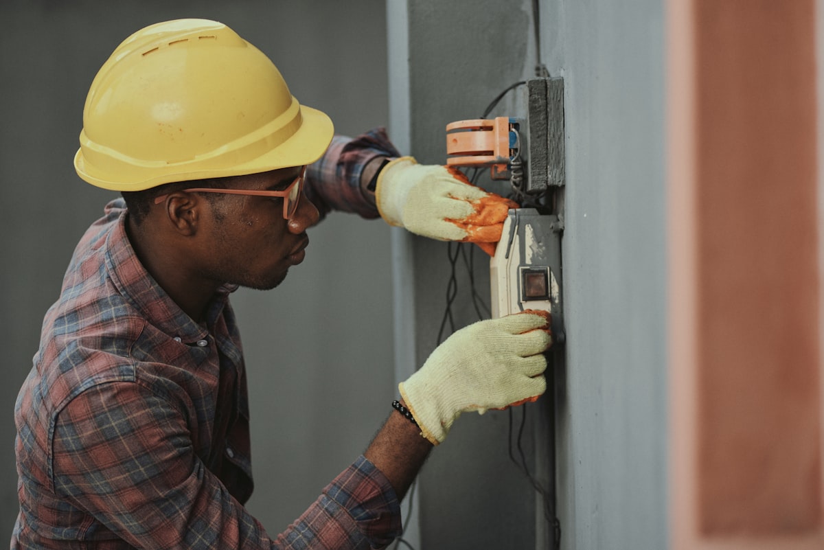Professional plumber working on pipes